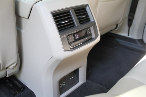 The 115-volt plug is under a trapdoor next to the two USB plugs on the back of the console.
